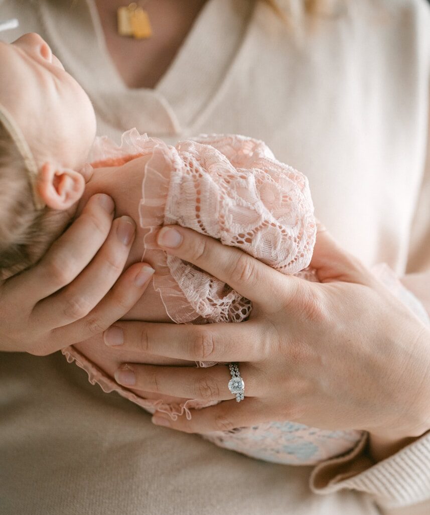 a woman holding a baby in her arms