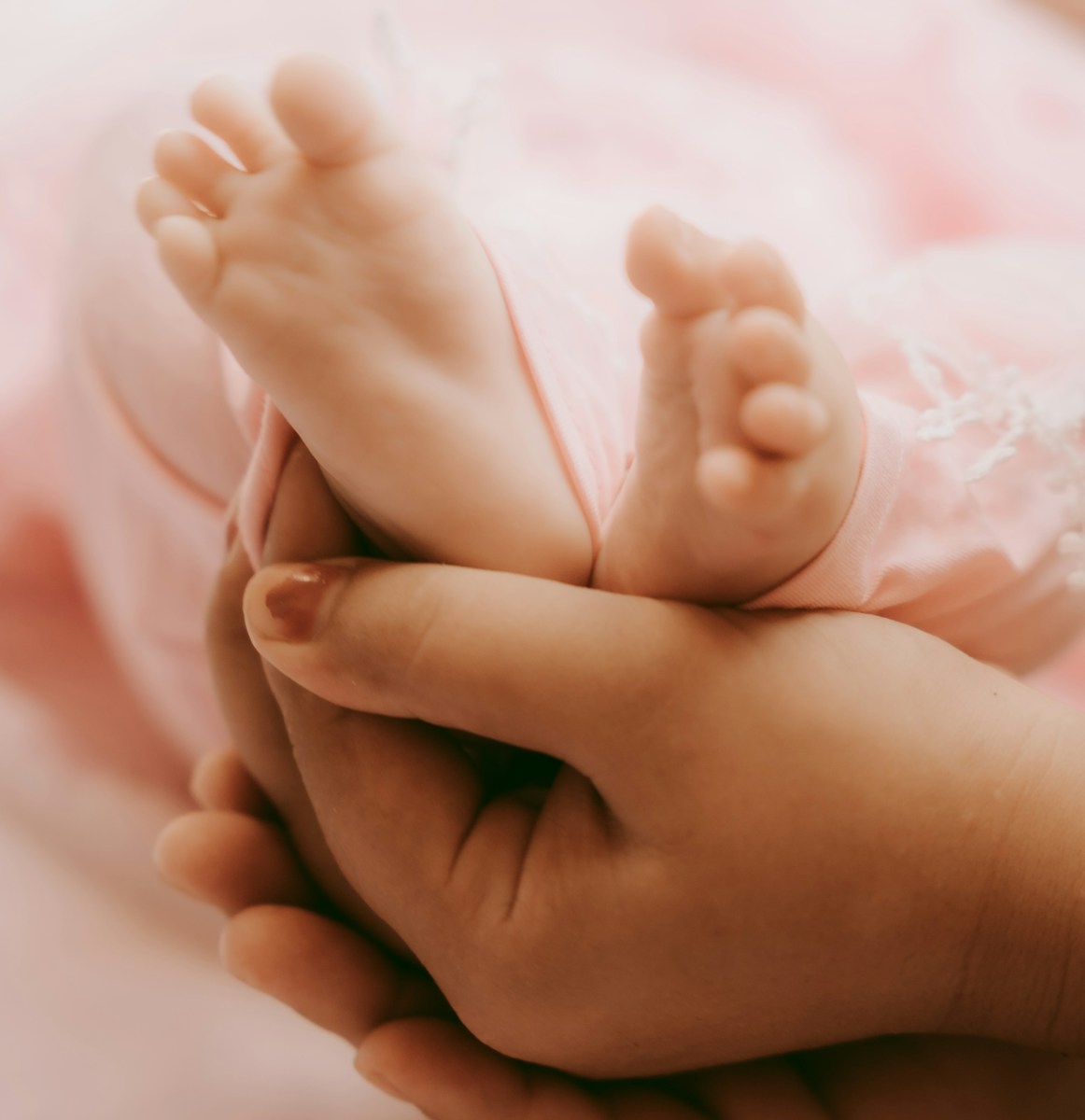 a close up of a person holding a baby